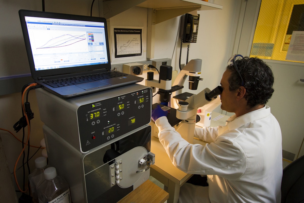 Medical laboratory technician working with a microscope